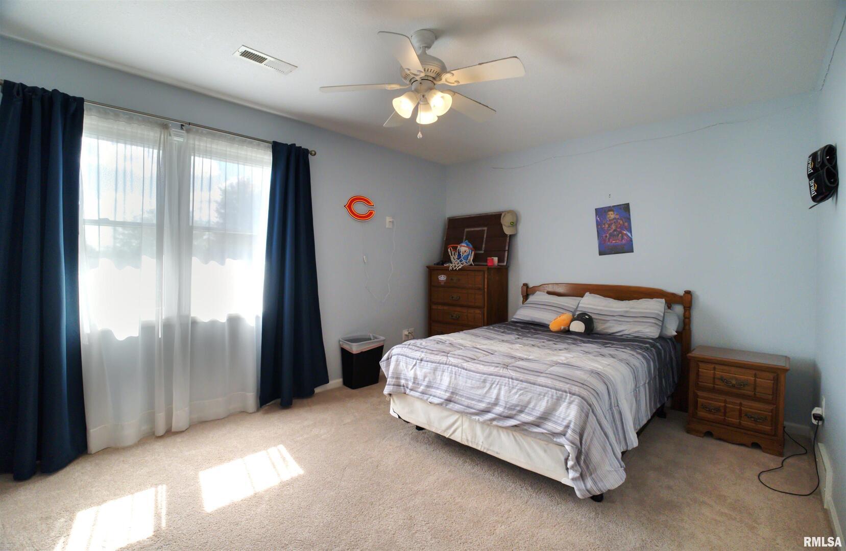 1917 11th Street Camanche, IA 52730 - Photo 25 of 40 a bedroom with a bed and a chandelier
