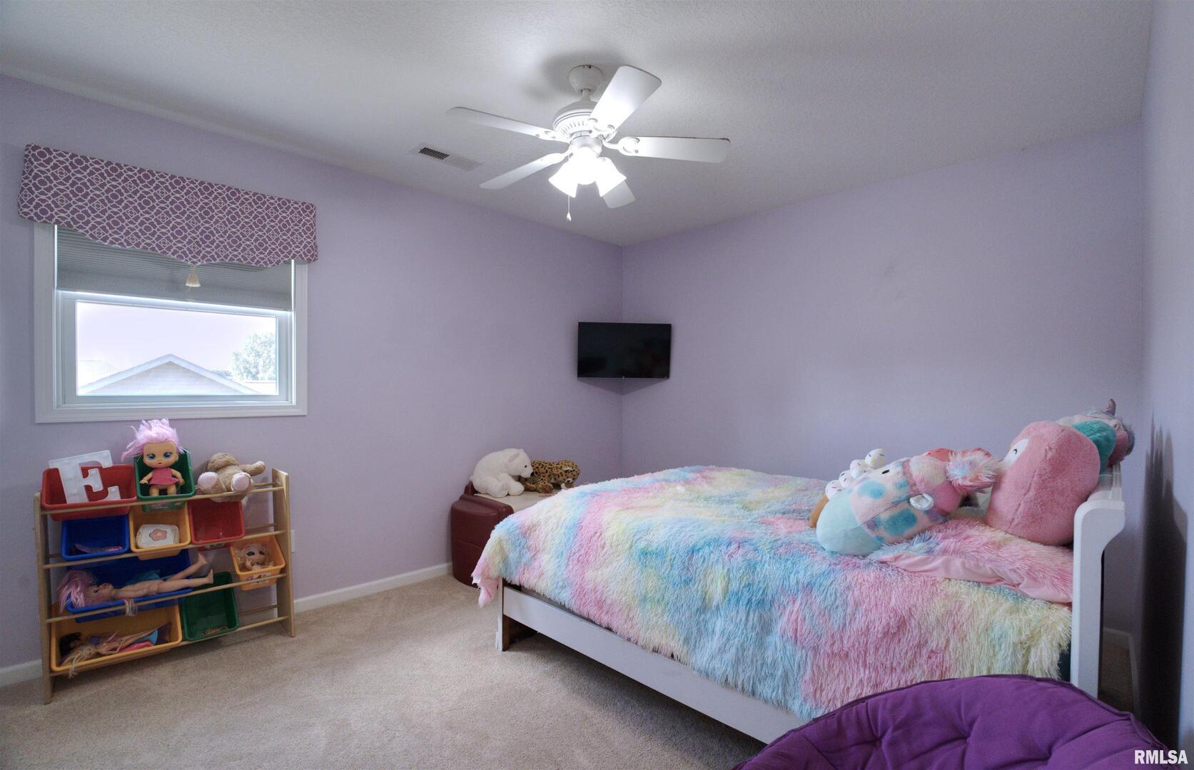 1917 11th Street Camanche, IA 52730 - Photo 26 of 40 a bedroom with a bed and a chandelier