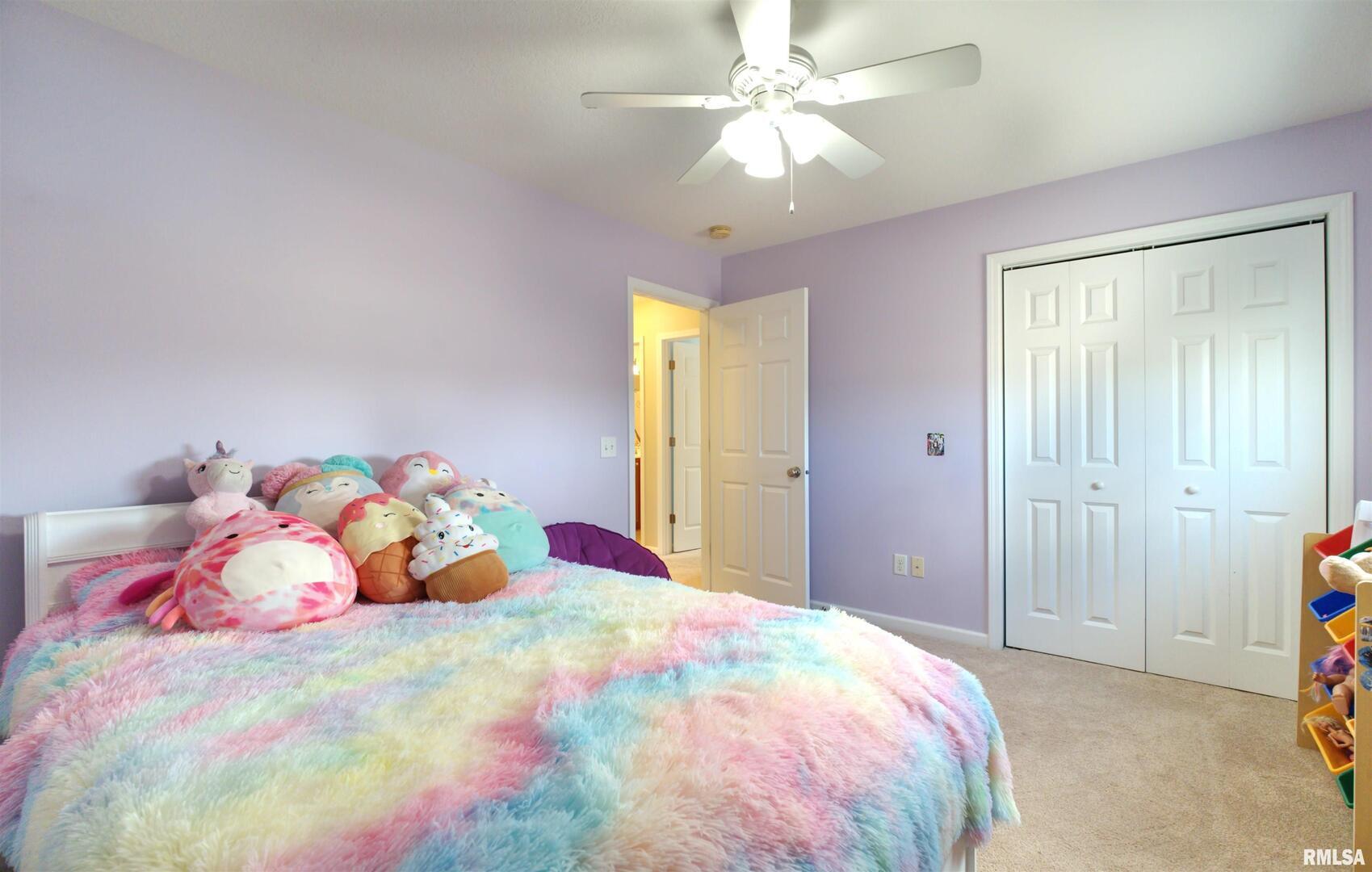 1917 11th Street Camanche, IA 52730 - Photo 27 of 40 a bedroom with a bed and a chandelier