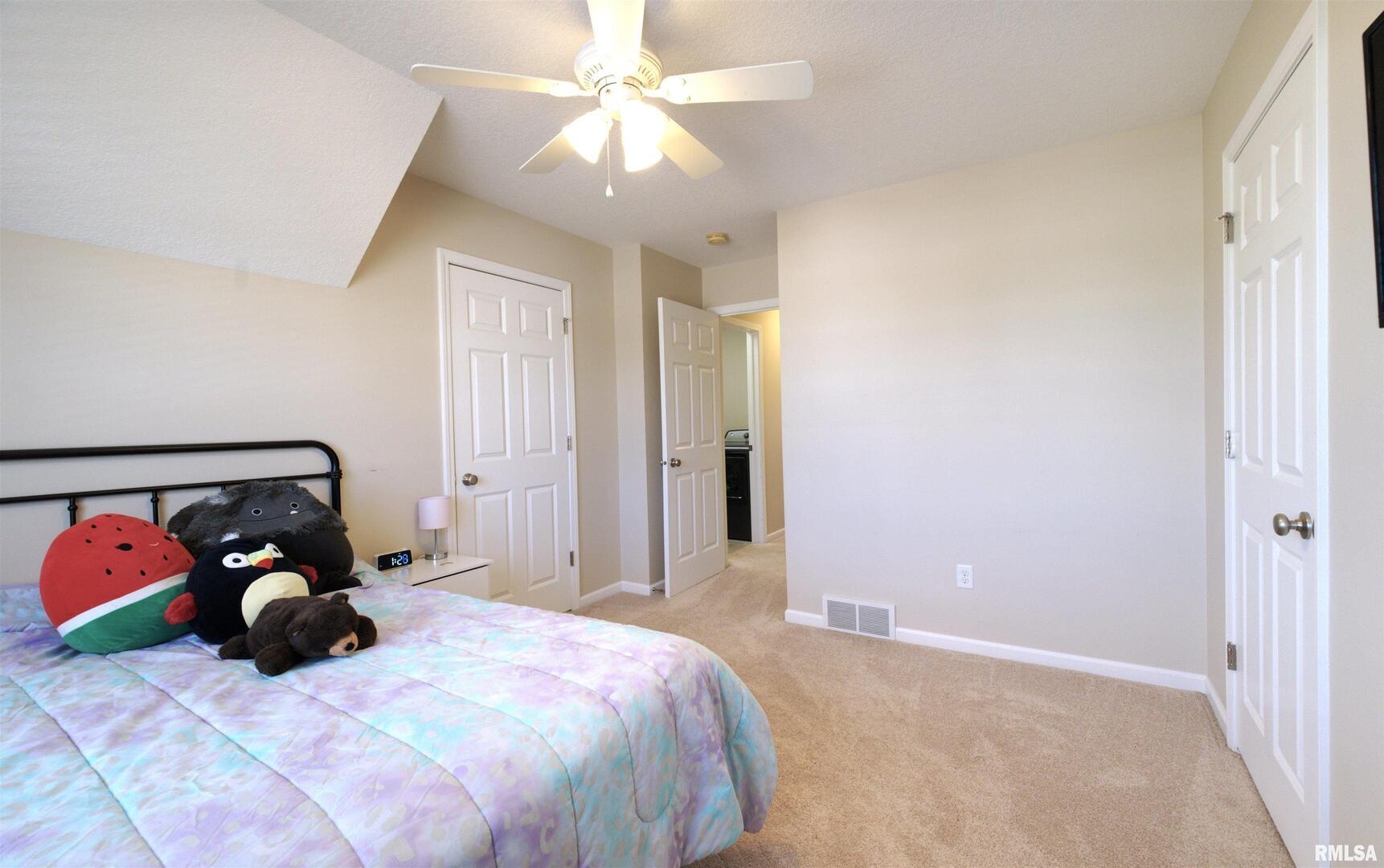 1917 11th Street Camanche, IA 52730 - Photo 28 of 40 a bedroom with a bed and a chandelier