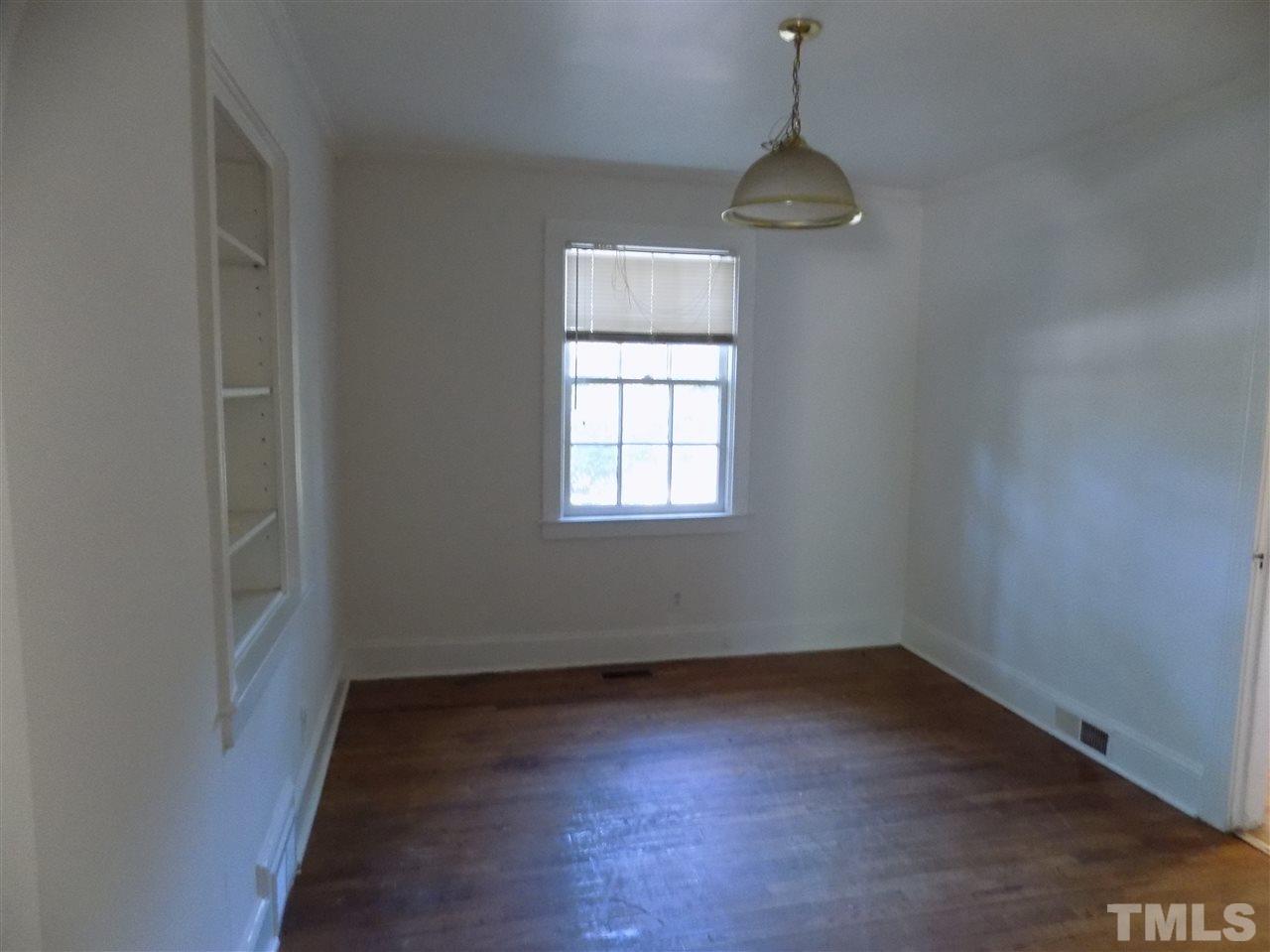 1114 Kent Road Raleigh, NC 27606 - Photo 3 of 10 an empty room with windows