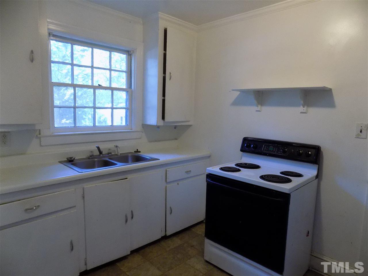 1114 Kent Road Raleigh, NC 27606 - Photo 5 of 10 a kitchen with stainless steel appliances granite countertop white cabinets and a stove top oven