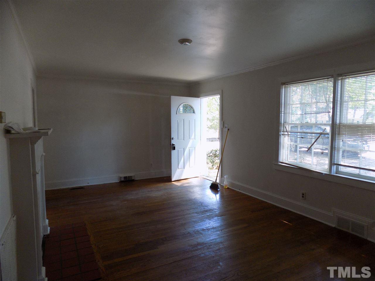 1114 Kent Road Raleigh, NC 27606 - Photo 6 of 10 an empty room with wooden floor and windows