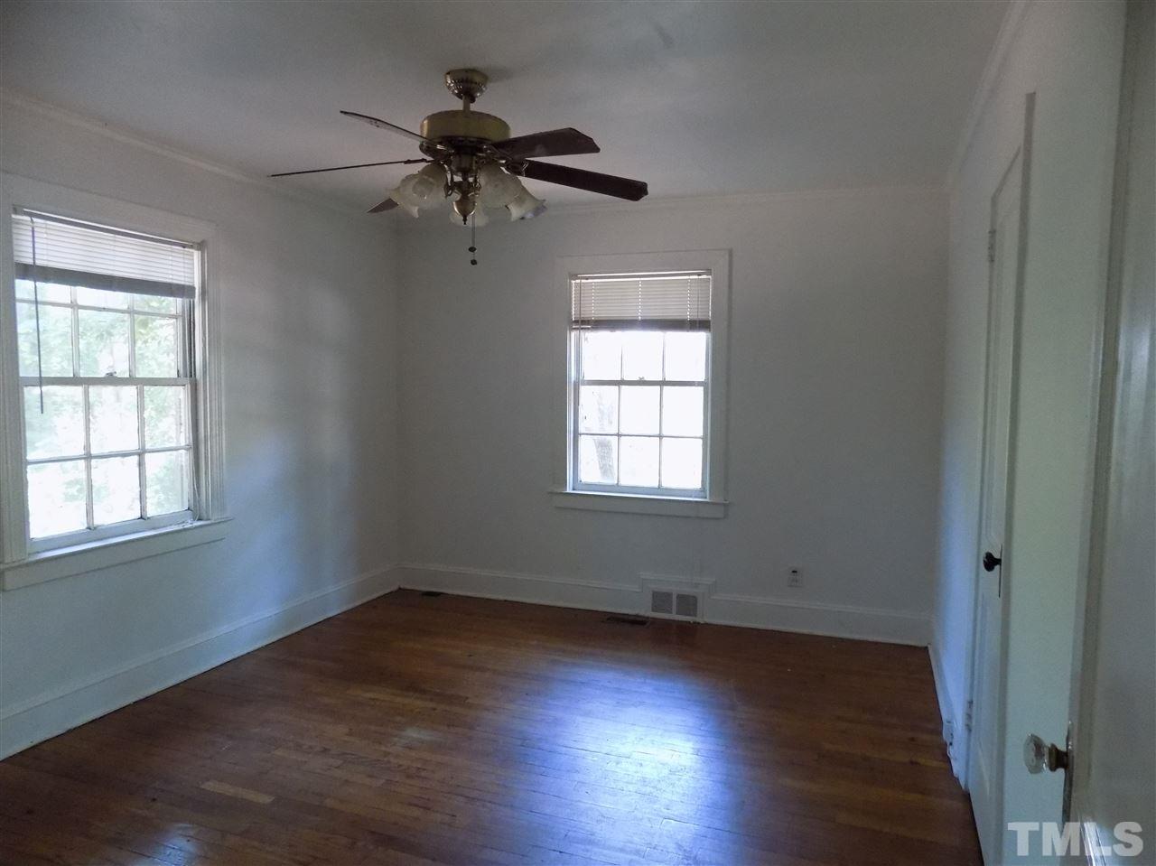 1114 Kent Road Raleigh, NC 27606 - Photo 7 of 10 an empty room with wooden floor closet and windows