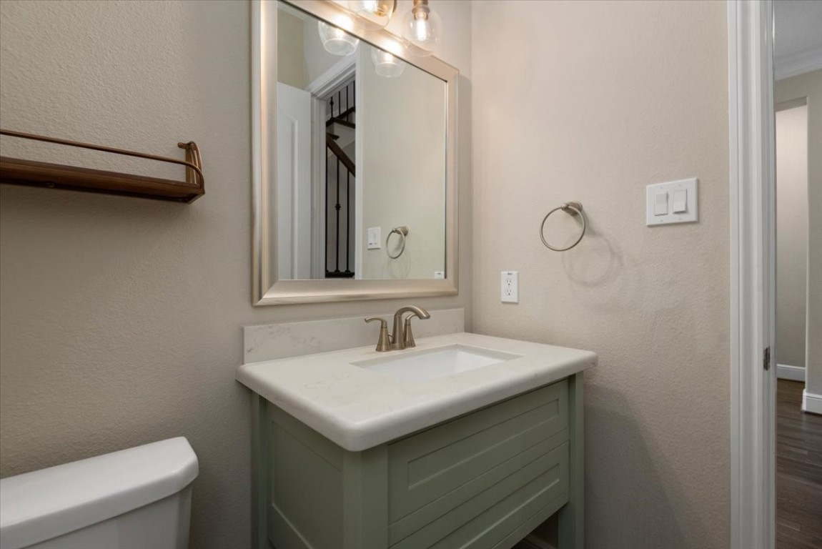 155 Rockwell Park Spring, TX 77389 - Photo 11 of 50 This half-bath features a modern vanity with a sleek white countertop and a stylish faucet. A large framed mirror is complemented by overhead lighting. Neutral walls and a towel ring add to the functional design.