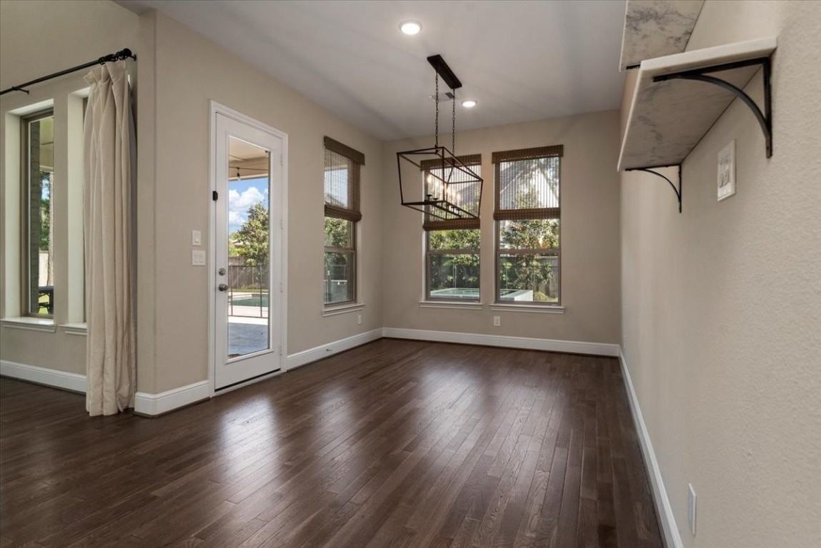 155 Rockwell Park Spring, TX 77389 - Photo 21 of 50 Start your mornings in this inviting breakfast nook, bathed in natural light with elegant hardwood floors, perfect for enjoying a peaceful meal while overlooking the serene backyard.