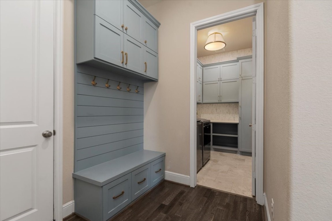 155 Rockwell Park Spring, TX 77389 - Photo 22 of 50 This charming mudroom at the garage entrance boasts elegant cabinetry and convenient hooks, combining style and functionality for seamless home organization.