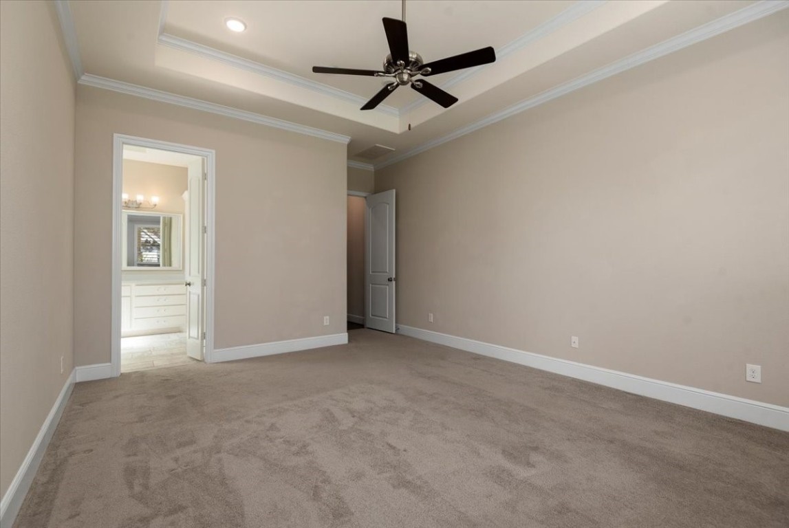 155 Rockwell Park Spring, TX 77389 - Photo 26 of 50 This room features neutral walls, carpet flooring, a ceiling fan, and recessed lighting. It opens to a bright bathroom with a double vanity and ample cabinet space.
