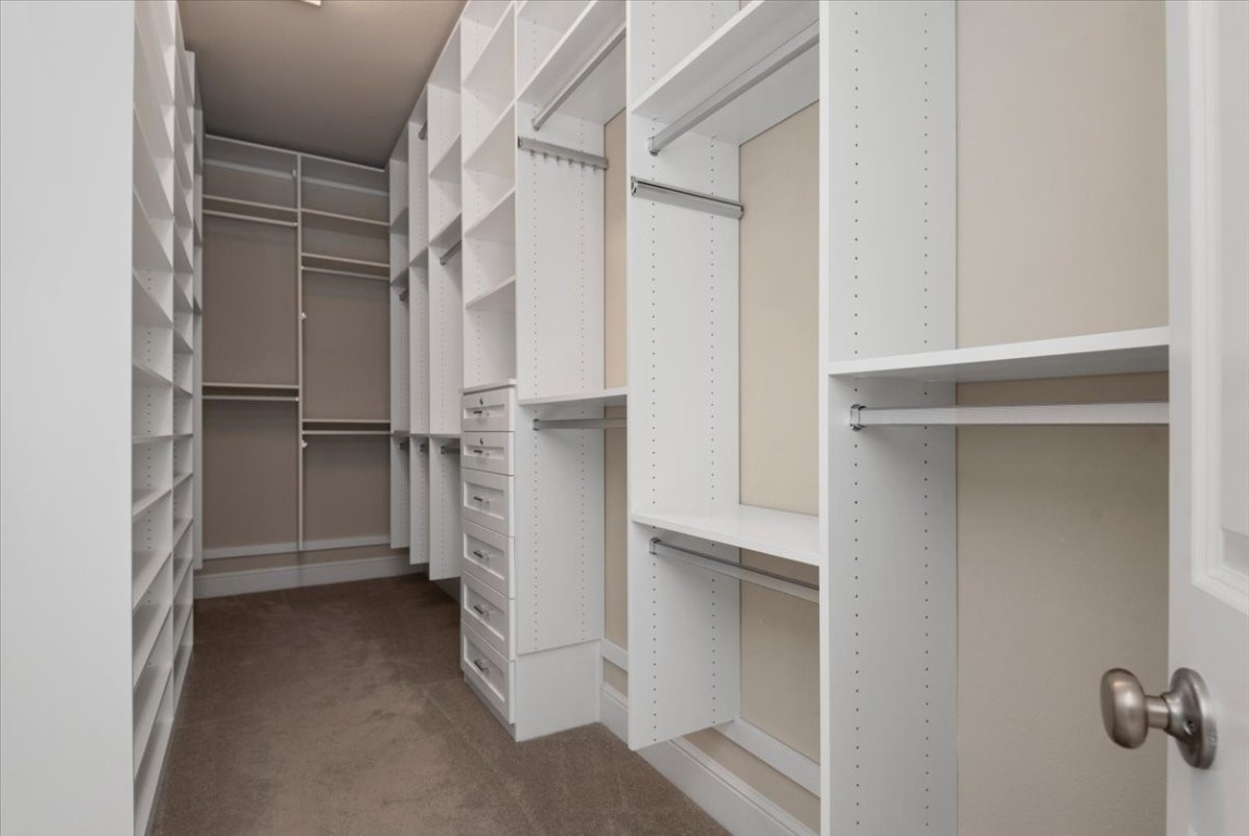 155 Rockwell Park Spring, TX 77389 - Photo 28 of 50 This spacious custom primary closet offers sleek, organized storage solutions for a luxurious and clutter-free lifestyle.