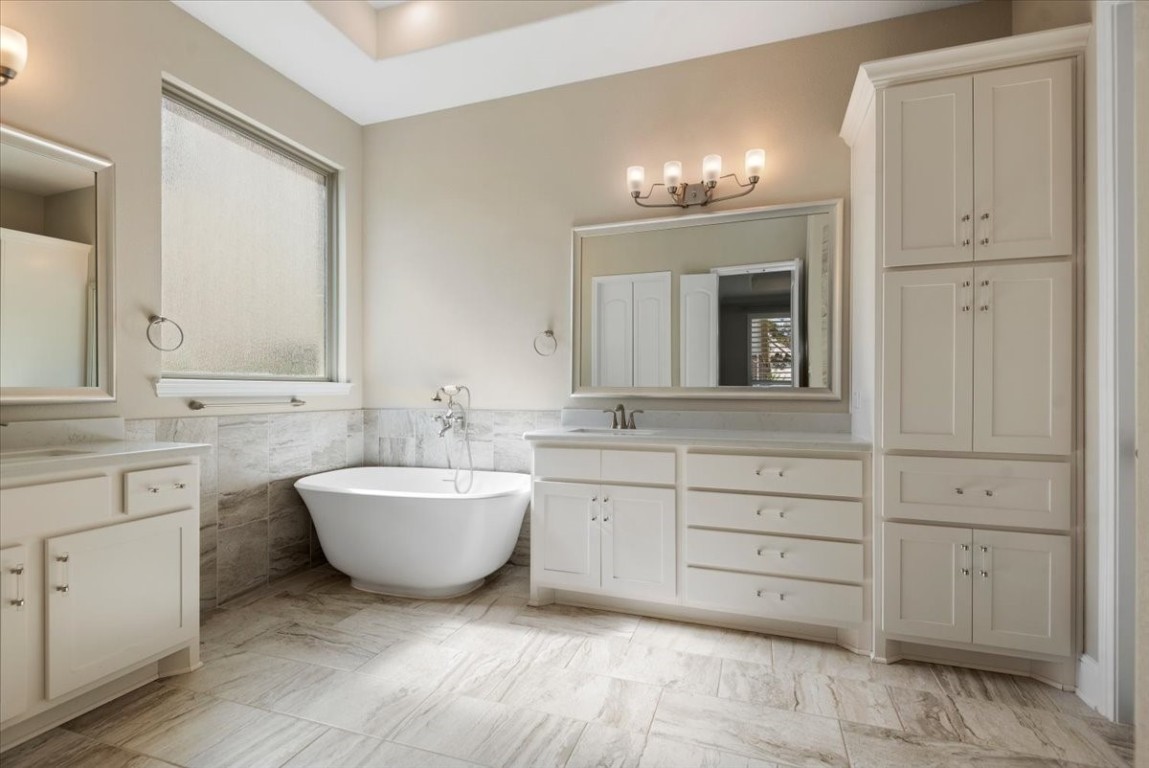 155 Rockwell Park Spring, TX 77389 - Photo 31 of 50 Experience luxury in this primary bath, featuring a stunning freestanding tub, elegant cabinetry, and a serene, spa-like ambiance perfect for relaxation.