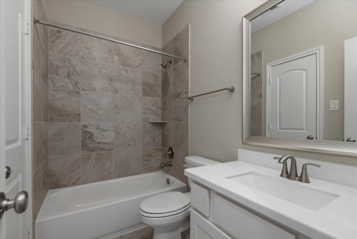 155 Rockwell Park Spring, TX 77389 - Photo 36 of 50 This elegant bathroom, featuring sleek fixtures and a modern design, offers convenient access directly from the game room, adding both style and functionality to bedroom 3.