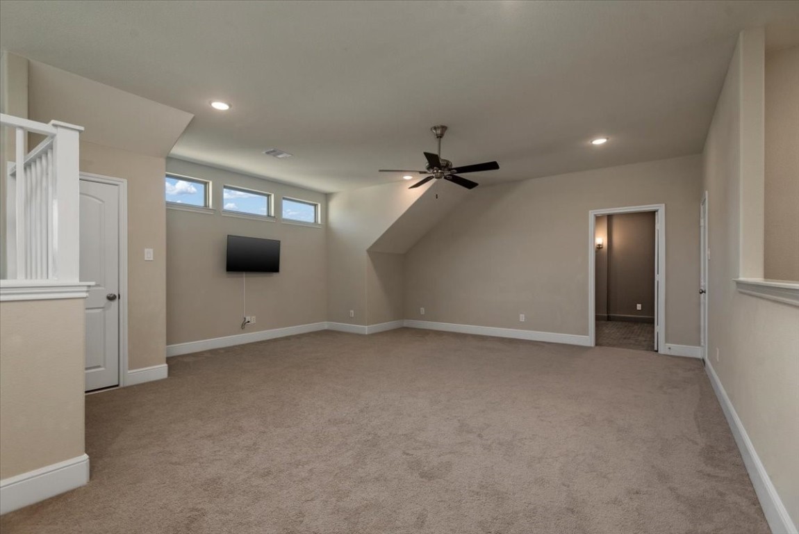 155 Rockwell Park Spring, TX 77389 - Photo 37 of 50 This spacious game room features soft carpeting, modern lighting, and a ceiling fan, perfect for entertaining or relaxing.