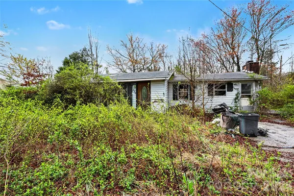a front view of a house with a yard garage and outdoor seating