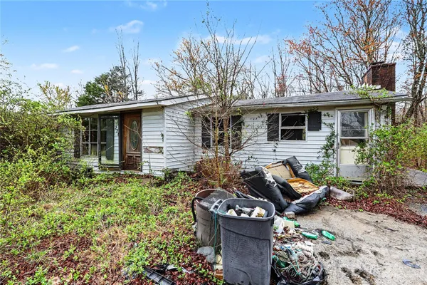 a view of a house with backyard and sitting area