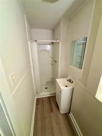 a bathroom with sink toilet and shower