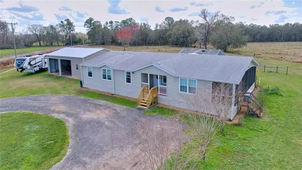 a view of a house with backyard and deck