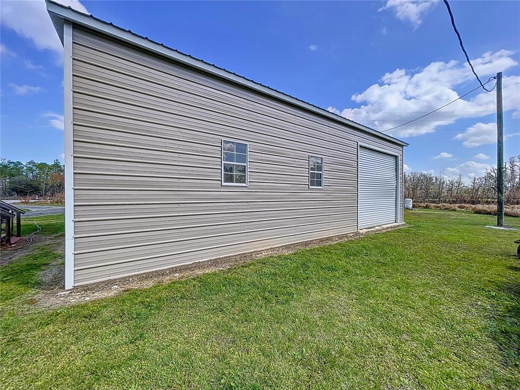 14890 County Road 757 Webster, FL 33597 - Photo 30 of 100 a view of a backyard with a garden