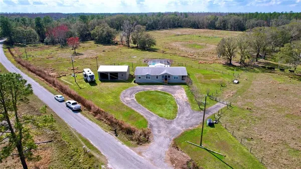 a spacious bedroom with a bed and a chandelier