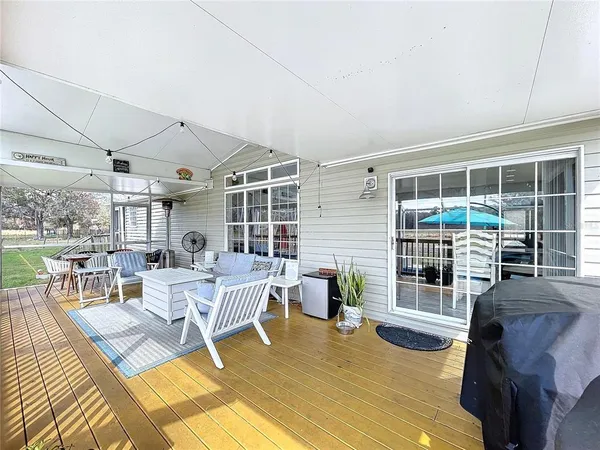 a dining room with furniture and wooden floor