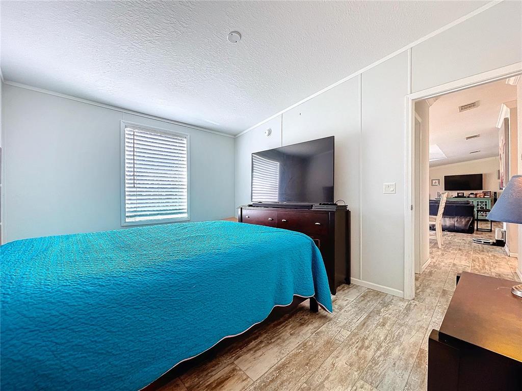 14890 County Road 757 Webster, FL 33597 - Photo 48 of 100 a bedroom with a bed and a flat tv screen on a dresser