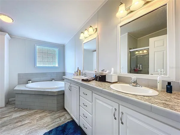 a front view of a house with a garden and trees