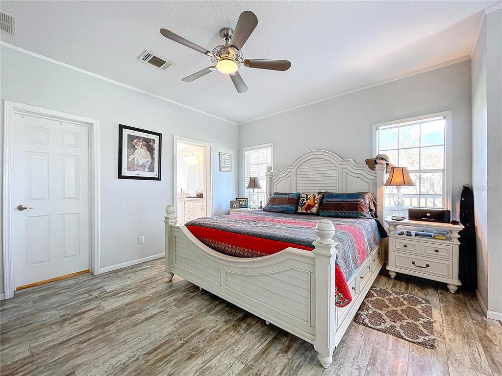 14890 County Road 757 Webster, FL 33597 - Photo 60 of 100 a bedroom with a bed and a chandelier
