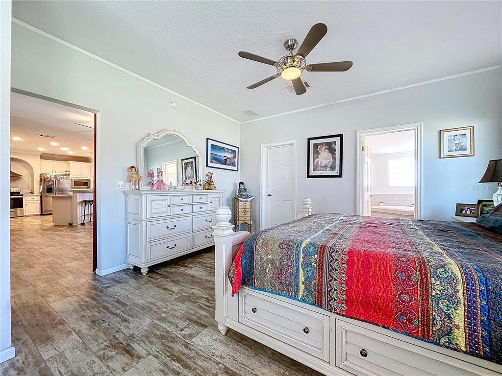 14890 County Road 757 Webster, FL 33597 - Photo 61 of 100 a bedroom with a bed and a chandelier