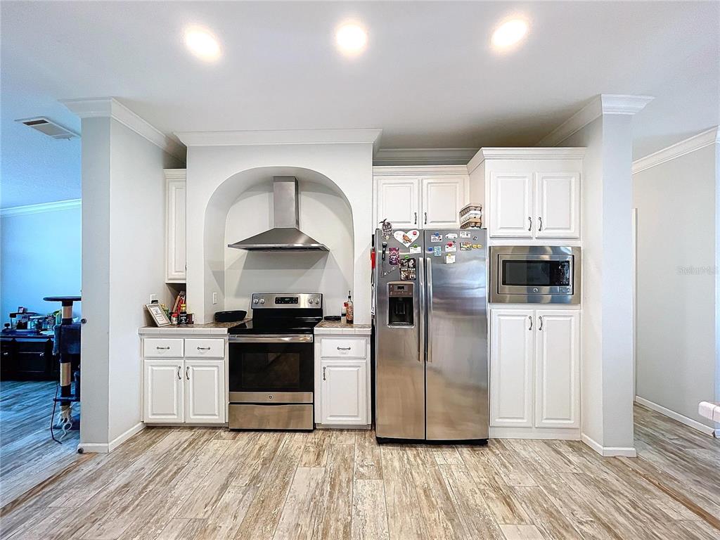 14890 County Road 757 Webster, FL 33597 - Photo 73 of 100 a kitchen with stainless steel appliances a stove a sink and a refrigerator