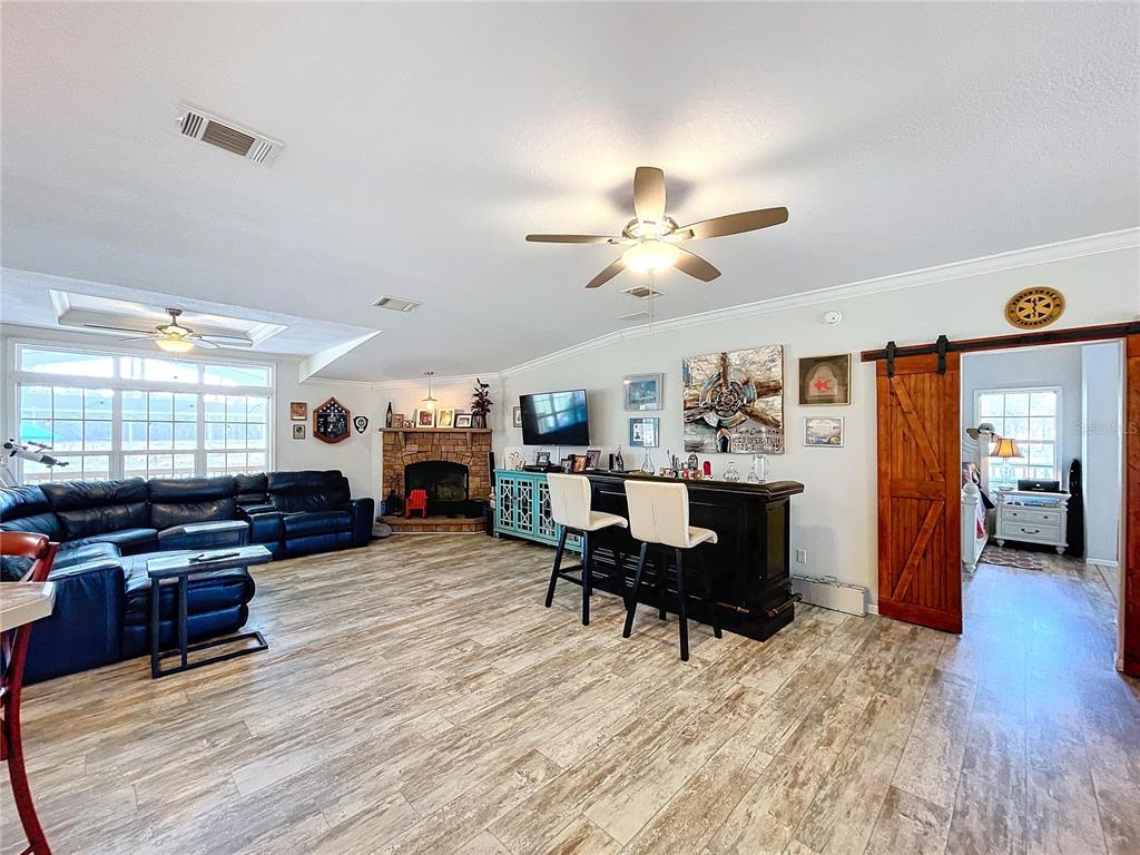 14890 County Road 757 Webster, FL 33597 - Photo 88 of 100 a living room with furniture kitchen view and a chandelier