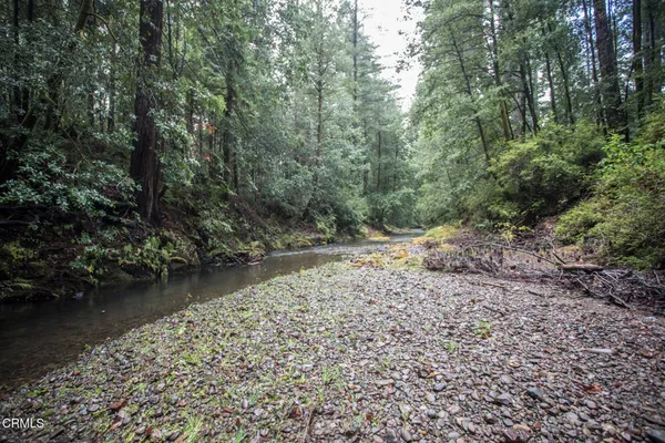 an aerial view of a house with a yard basket ball court and outdoor seating