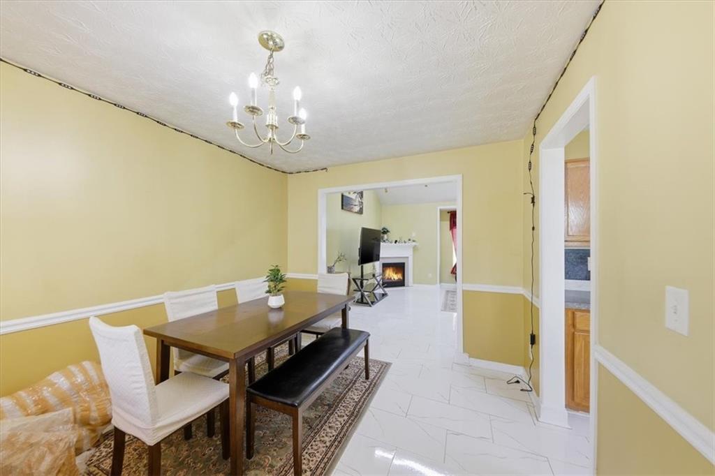 109 Tyler Way Jackson, GA 30233 - Photo 12 of 44 a view of a dining room with furniture and a chandelier