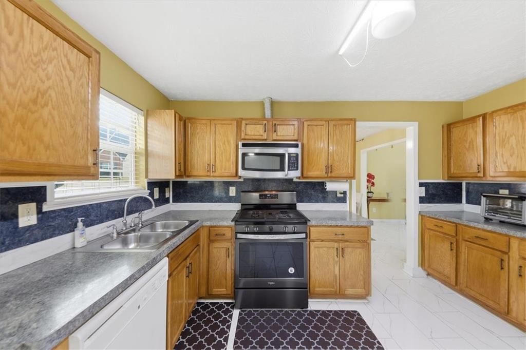 109 Tyler Way Jackson, GA 30233 - Photo 16 of 44 a kitchen with a sink stove and cabinets