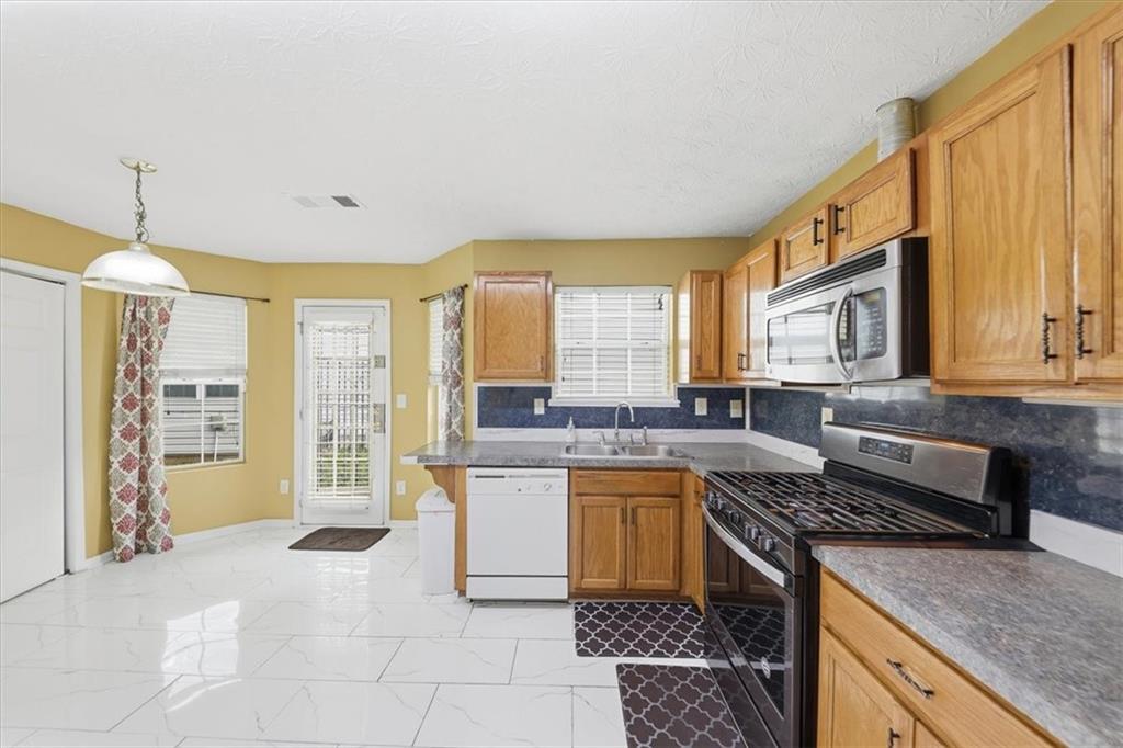 109 Tyler Way Jackson, GA 30233 - Photo 17 of 44 a kitchen with a stove a sink and a refrigerator