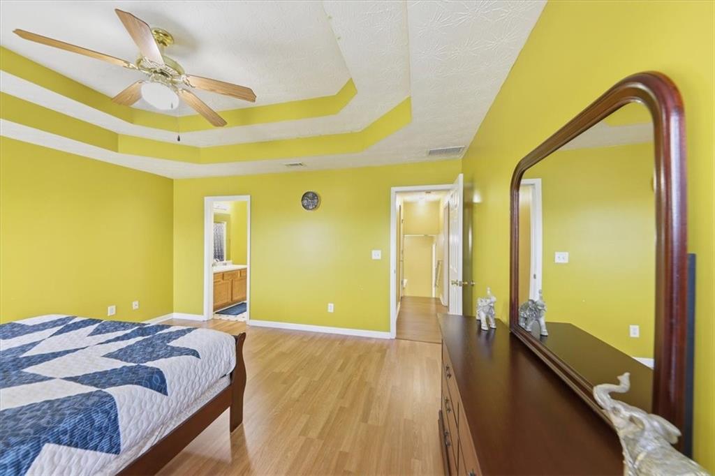 109 Tyler Way Jackson, GA 30233 - Photo 22 of 44 a bedroom with a bed and a dresser