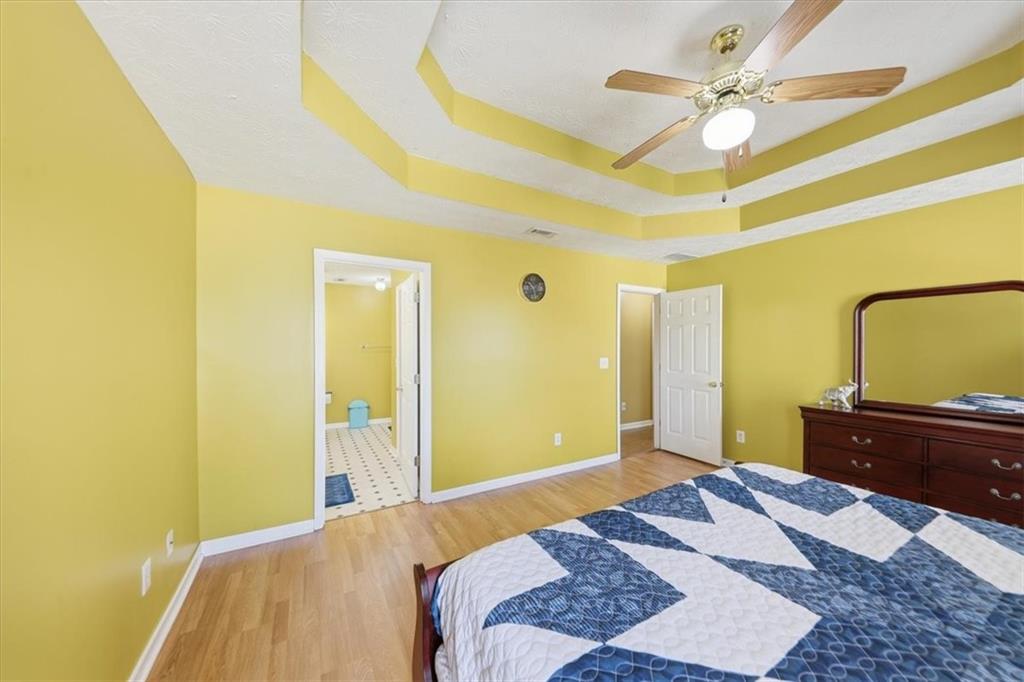 109 Tyler Way Jackson, GA 30233 - Photo 23 of 44 a bedroom with a bed and a chandelier