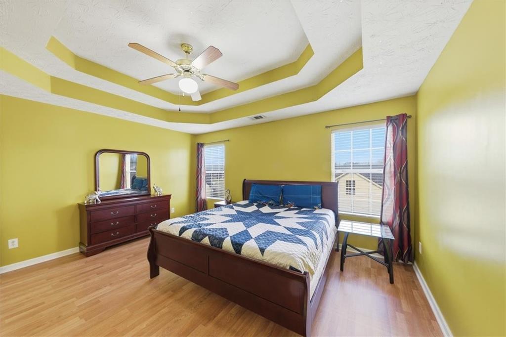 109 Tyler Way Jackson, GA 30233 - Photo 24 of 44 a bedroom with a bed and a dresser with rug