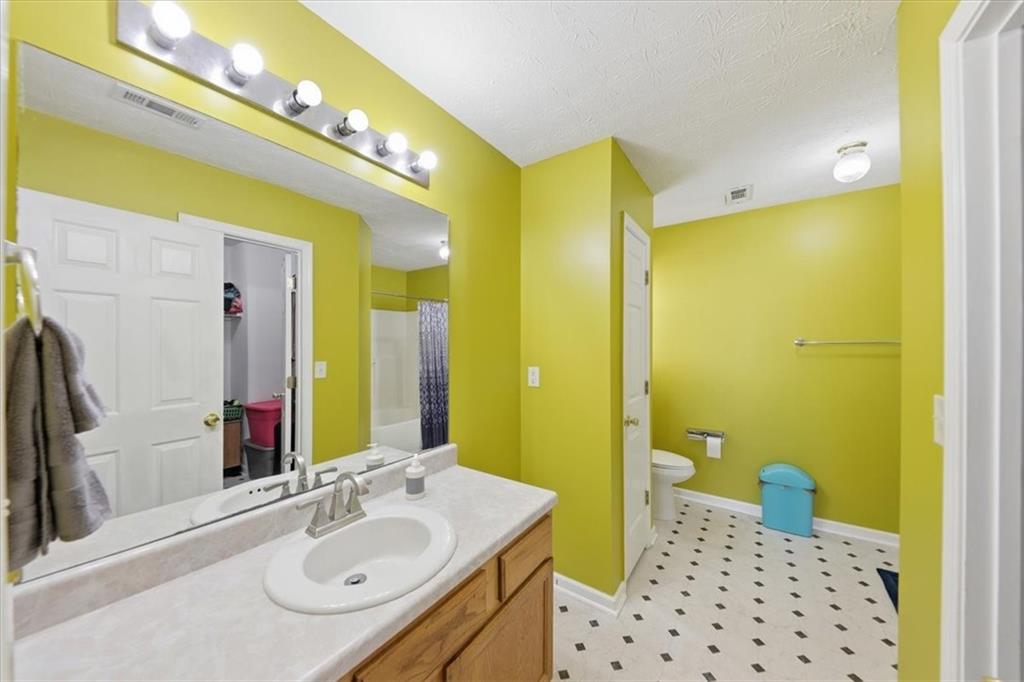 109 Tyler Way Jackson, GA 30233 - Photo 25 of 44 a bathroom with a sink and a mirror