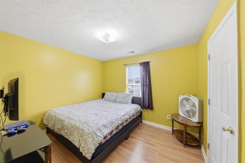 109 Tyler Way Jackson, GA 30233 - Photo 29 of 44 a bedroom with a bed and a flat screen tv