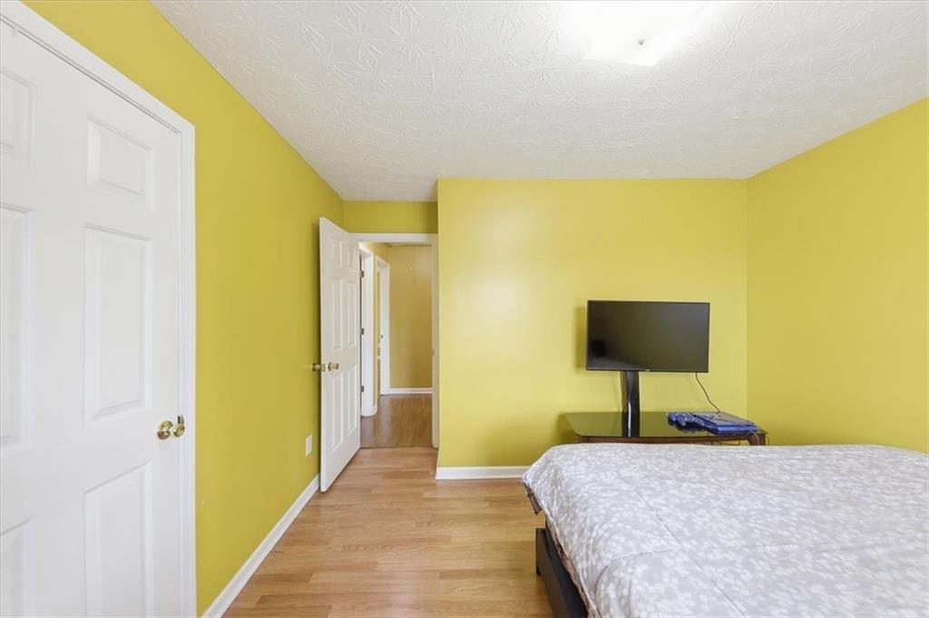 109 Tyler Way Jackson, GA 30233 - Photo 30 of 44 a bedroom with a bed and a lamp