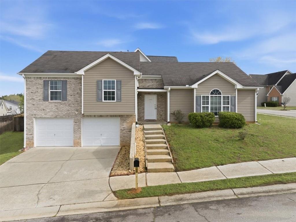 109 Tyler Way Jackson, GA 30233 - Photo 4 of 44 a front view of a house with a yard