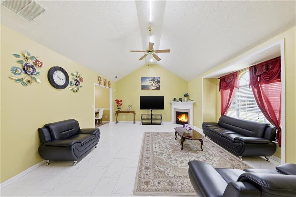 109 Tyler Way Jackson, GA 30233 - Photo 8 of 44 a living room with furniture a fireplace and a flat screen tv