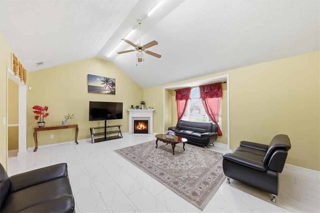 109 Tyler Way Jackson, GA 30233 - Photo 9 of 44 a living room with furniture and a flat screen tv