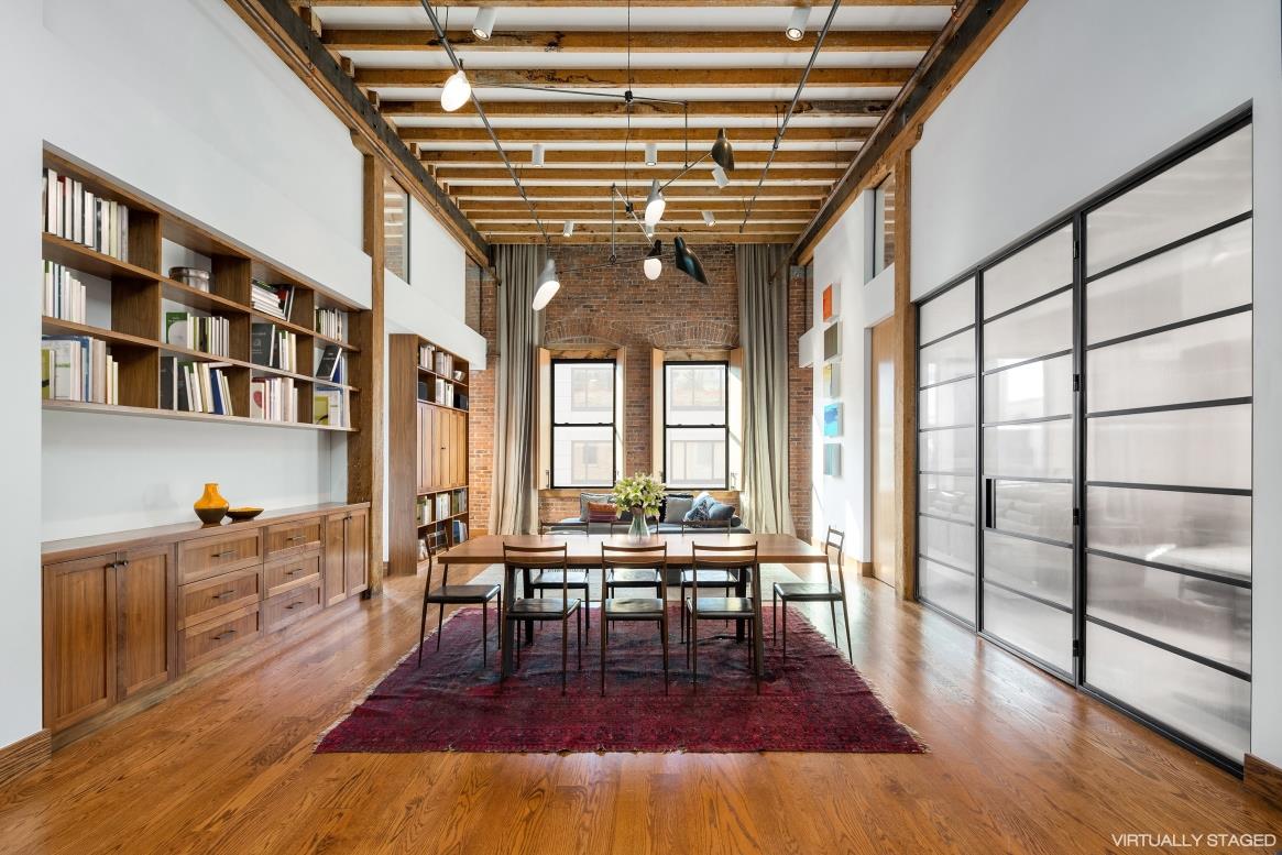 85 North 3rd Street, Unit 514 Brooklyn, NY 11249 - Photo 1 of 1 a living room with furniture a large window and wooden floor