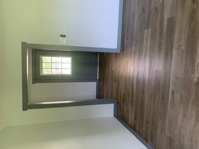 1501 North Burleson Street Kyle, TX 78640 - Photo 11 of 33 a view of an empty room with wooden floor and a window