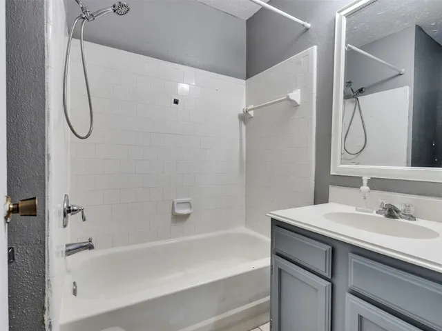 a bathroom with a sink a mirror and a shower