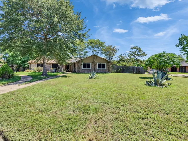 a house view with swimming pool and garden space