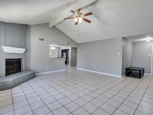 a view of an empty room and fire place