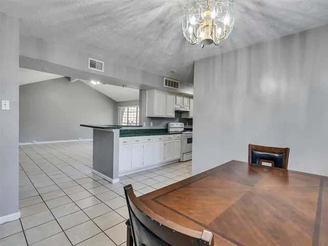 a kitchen with cabinets and wooden floor