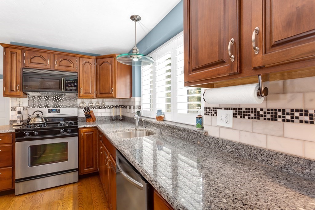 8 Mill River Drive Mendon, MA 01756 - Photo 14 of 42 a kitchen with stainless steel appliances granite countertop a stove a sink and a microwave