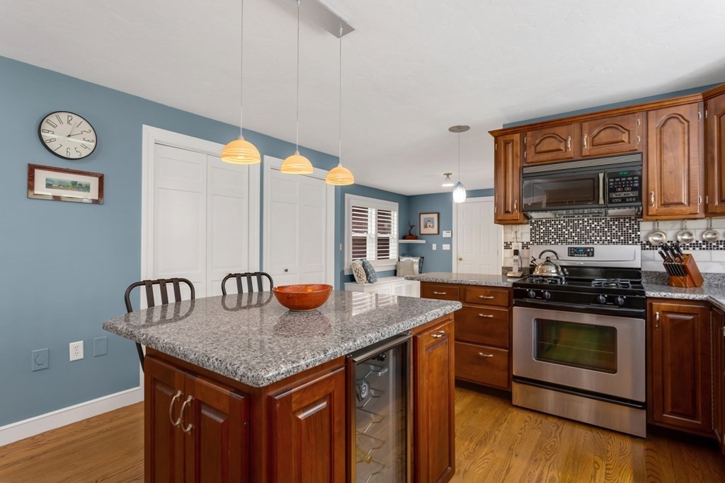 8 Mill River Drive Mendon, MA 01756 - Photo 17 of 42 a kitchen with granite countertop stainless steel appliances and wooden cabinets